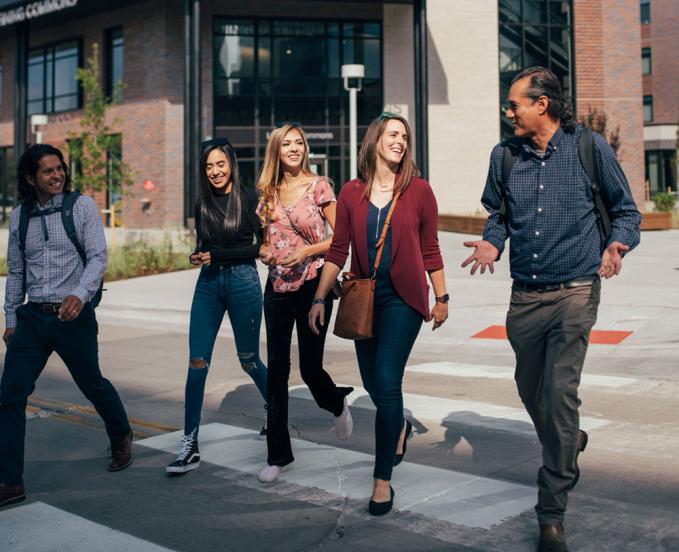 CU Denver students talking while crossing street in downtown Denver