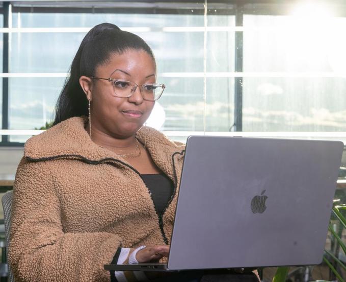 CU Denver student using computer to look up available scholarships