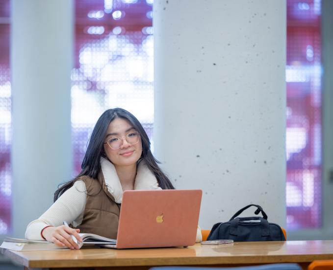 Cu-denver-student-on-laptop-smiling