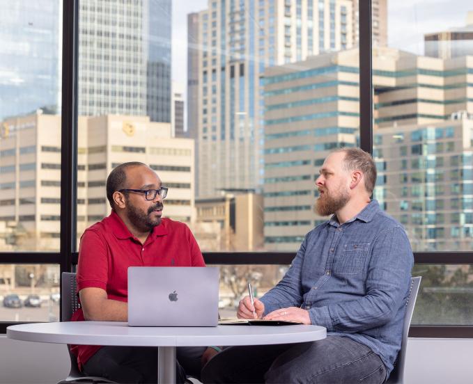 CU Denver students talking in a campus office
