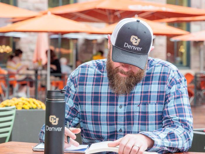 CU Denver online student working outside in downtown