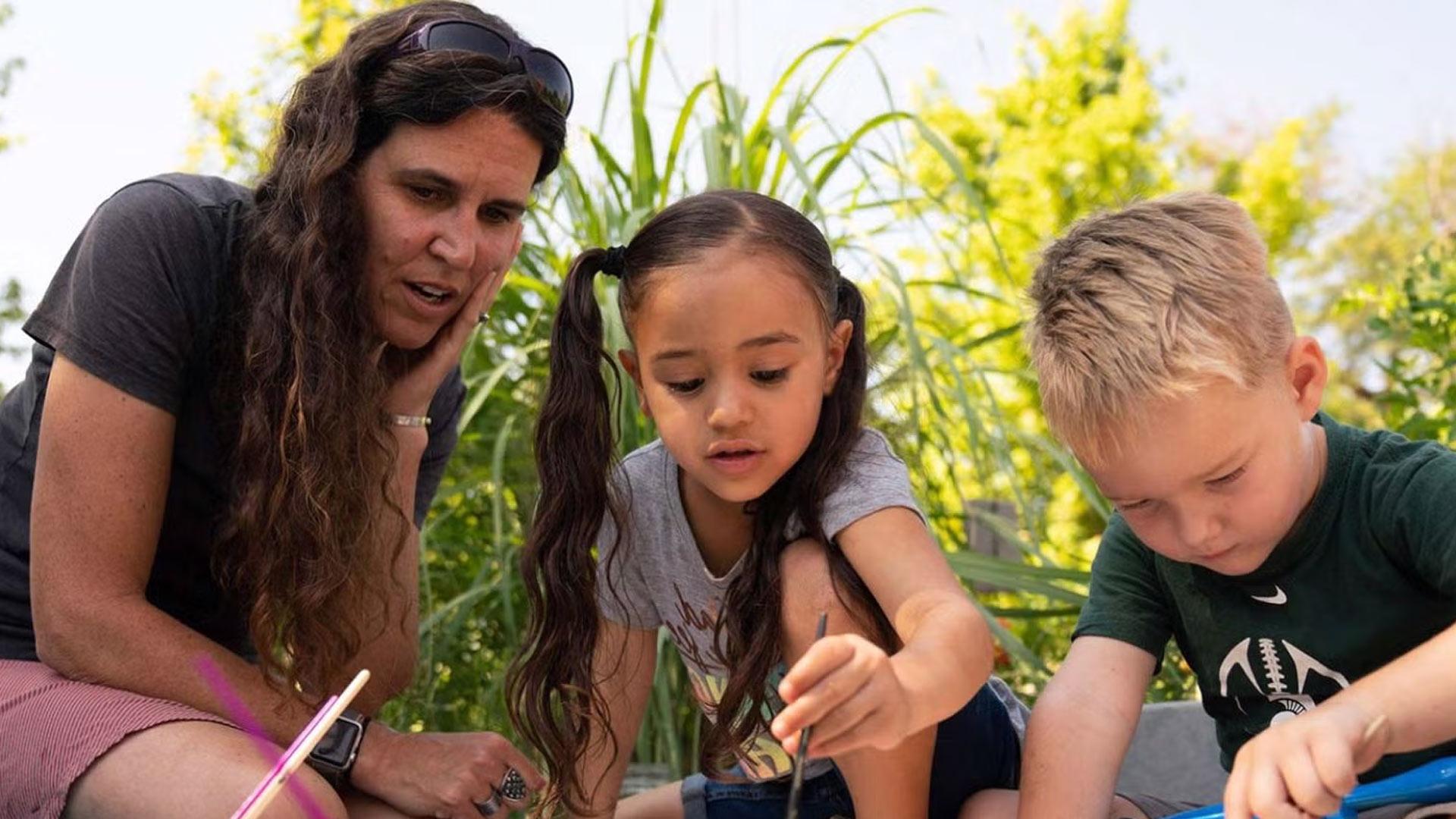 CU Denver education student working outside with kids
