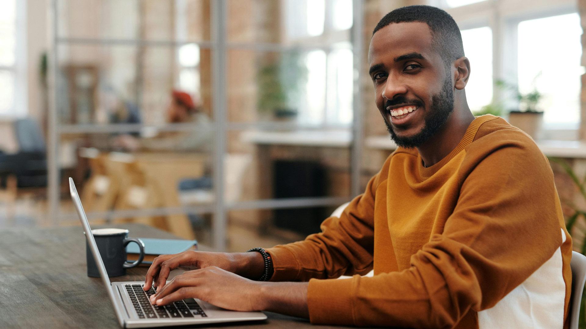 CU Denver online student at home using his laptop