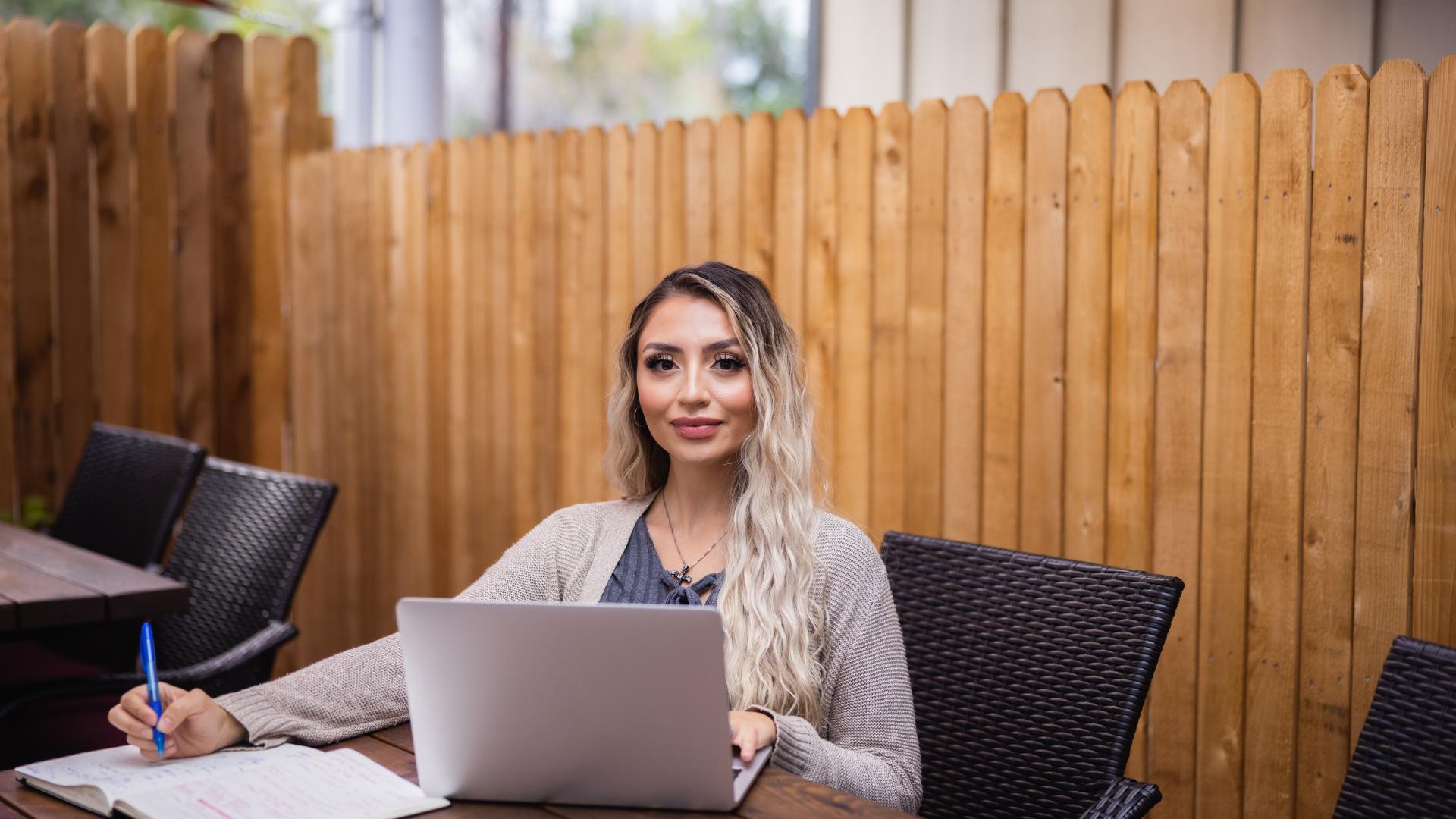 Online sociology student working on laptop.