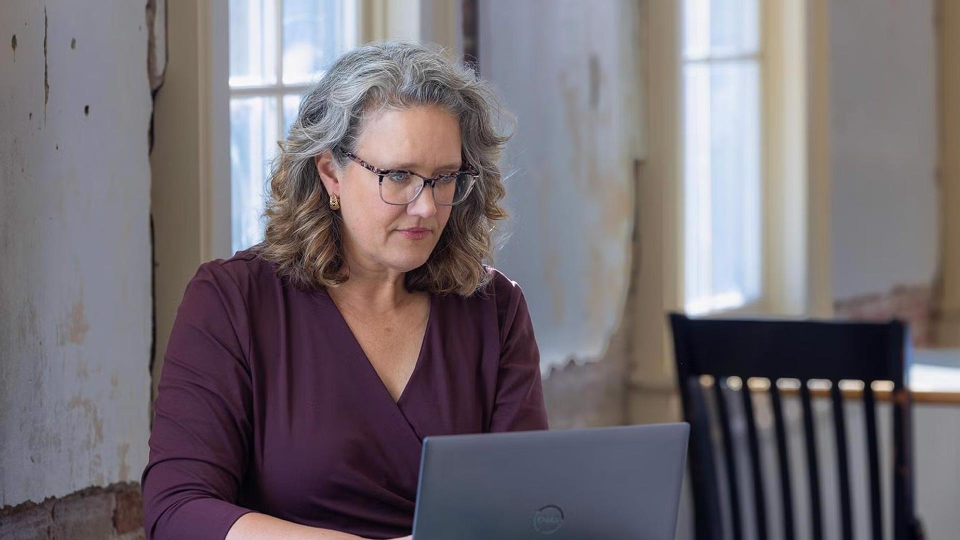 CU Denver master's student using laptop