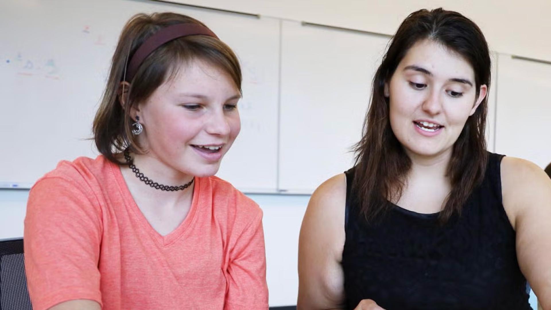 Teacher working with student on class work