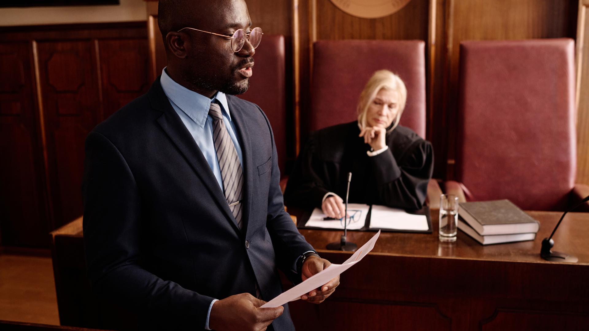 A male lawyer speaks in court
