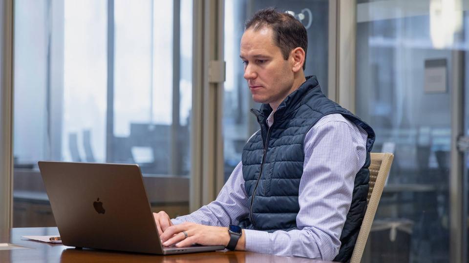 CU Denver MBA student working on laptop