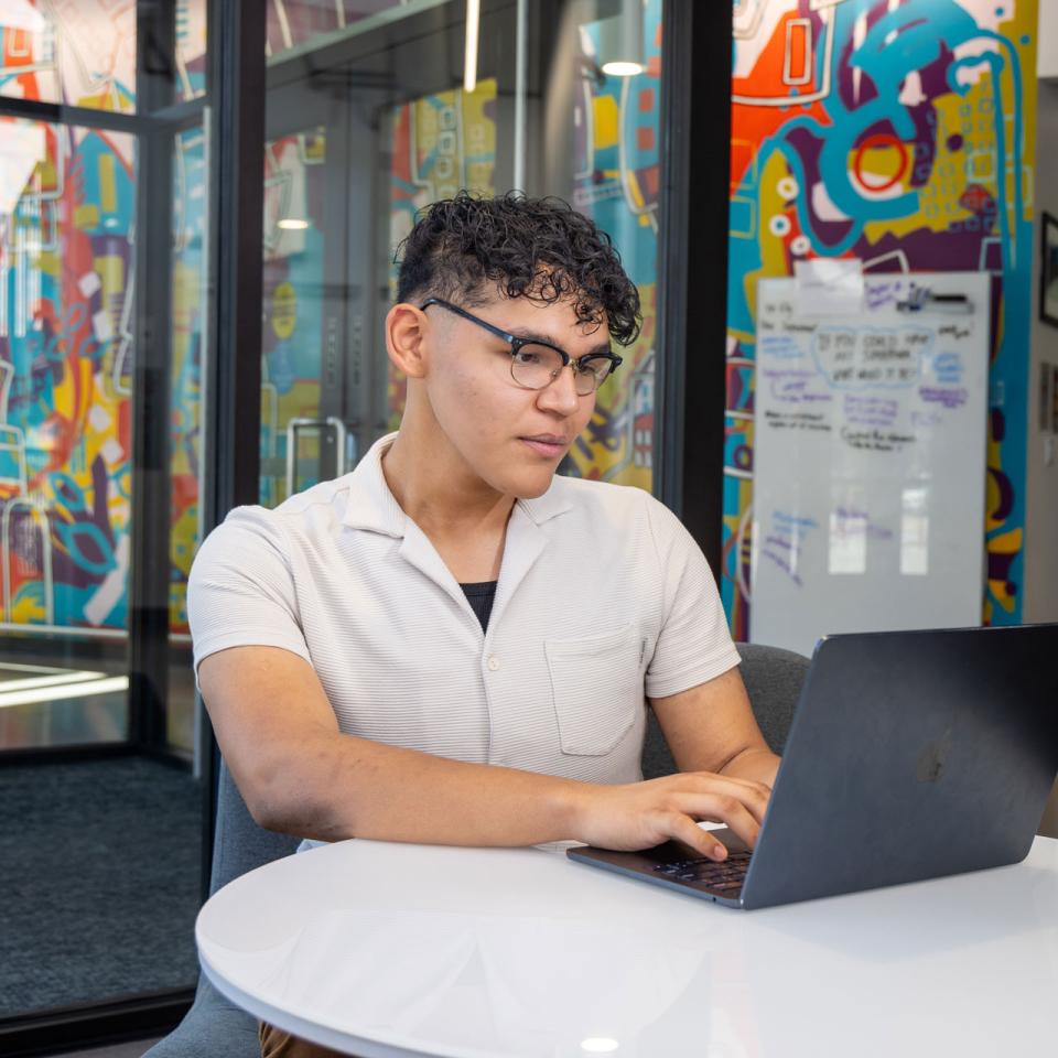 CU Denver online student working on a laptop