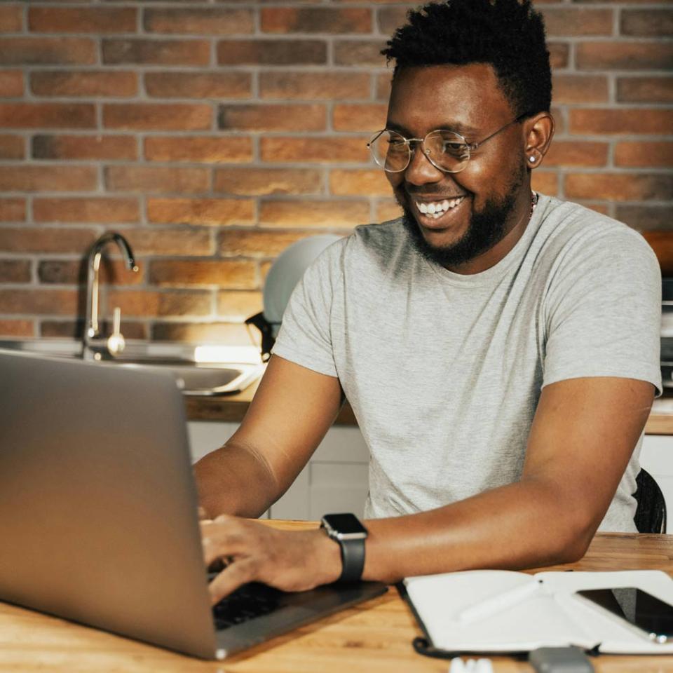 CU Denver student working on marketing courses in their kitchen