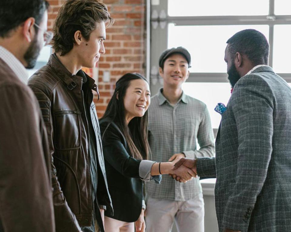 Business professionals shaking hands during meeting